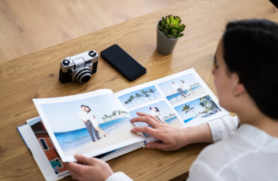 Women sat at table looking at photo album