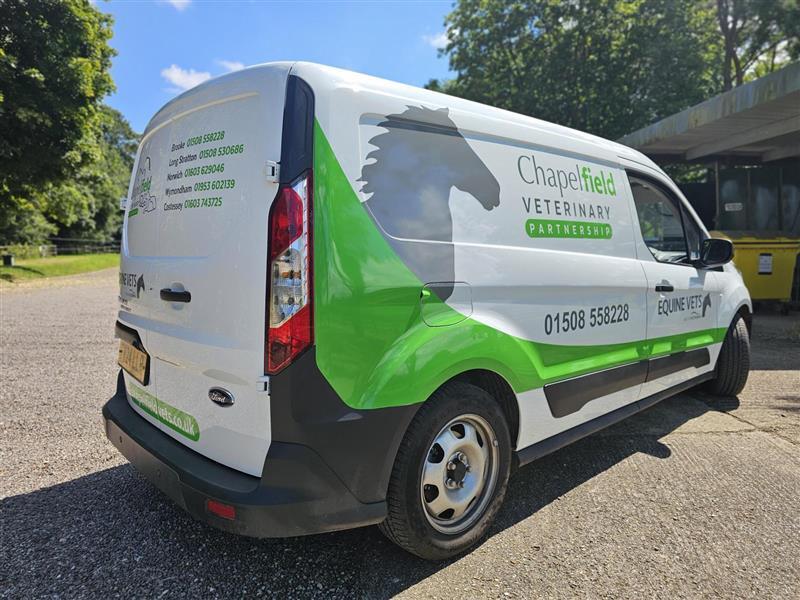 white caddy van with vinyl stickers applied